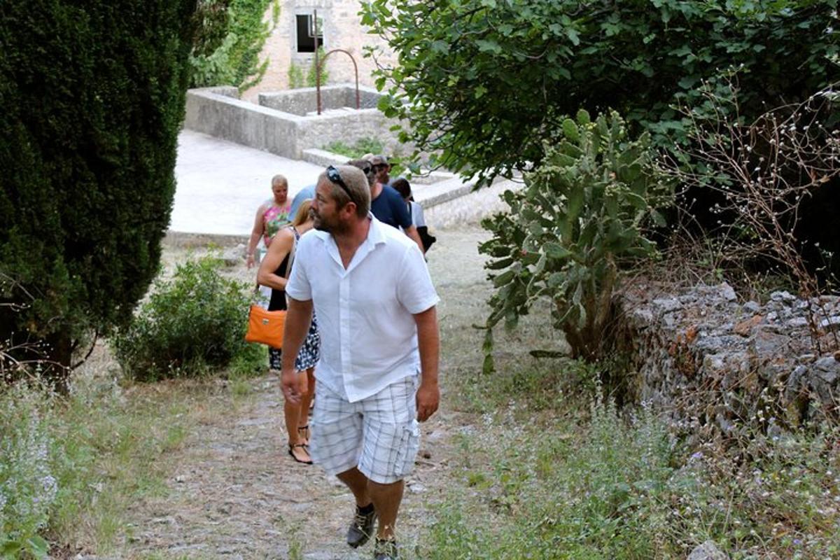 a man walking down a path with a group of people