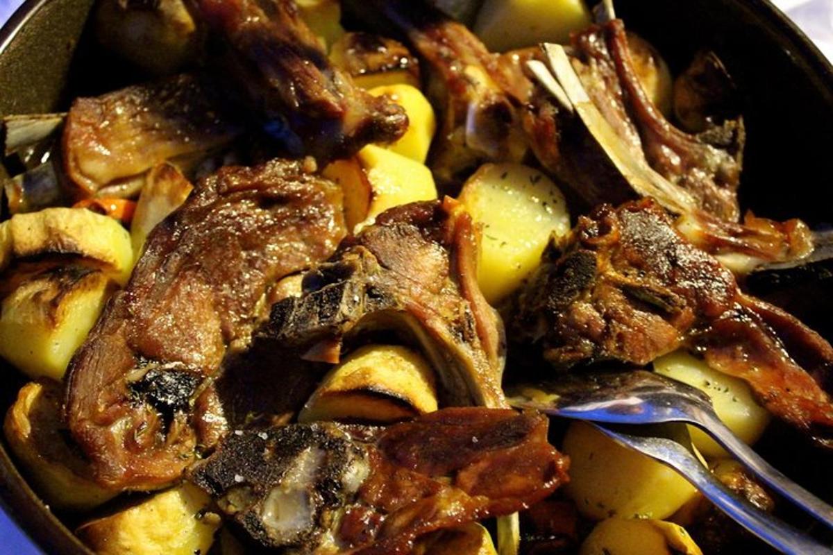 a bowl of food with meat and potatoes