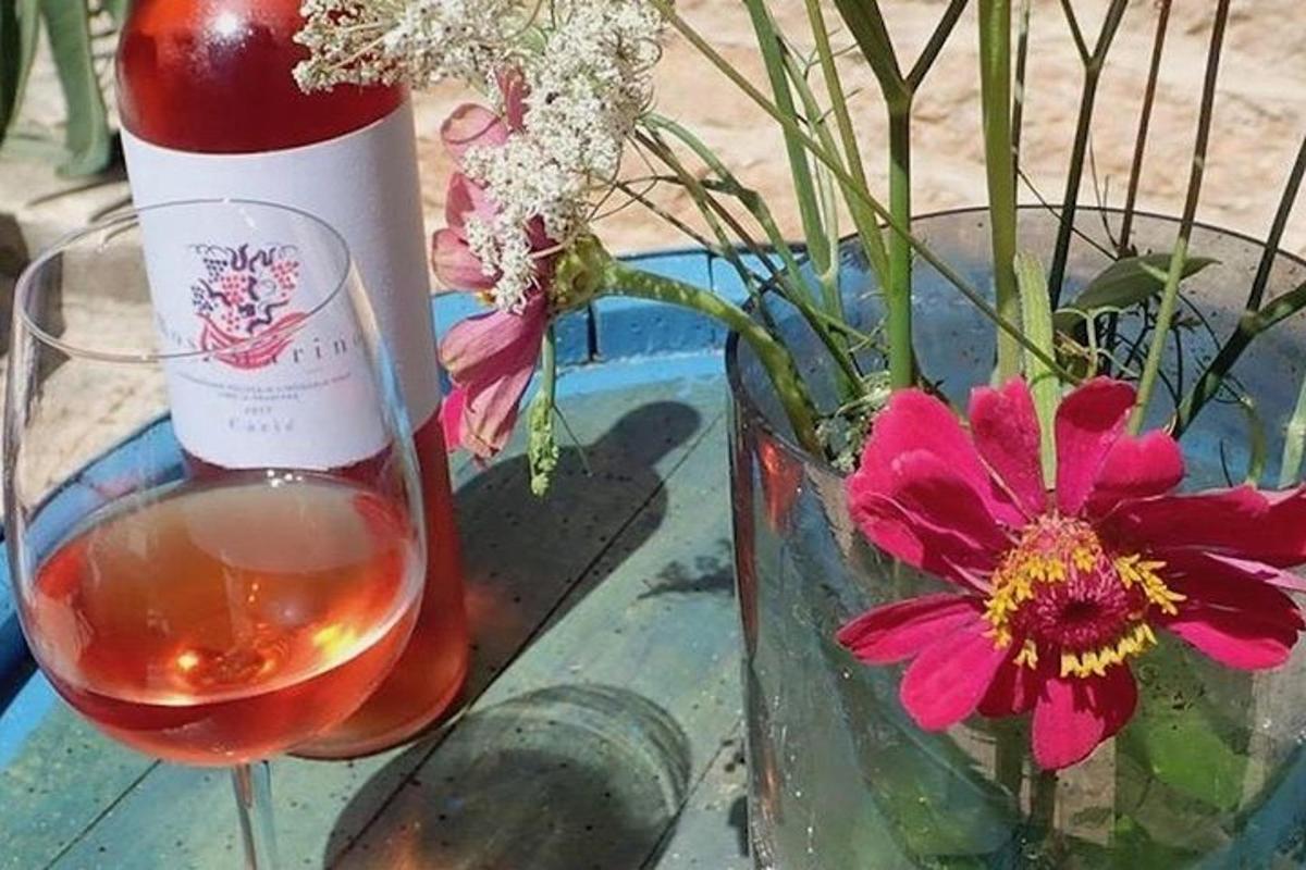 a bottle of wine next to a vase with flowers