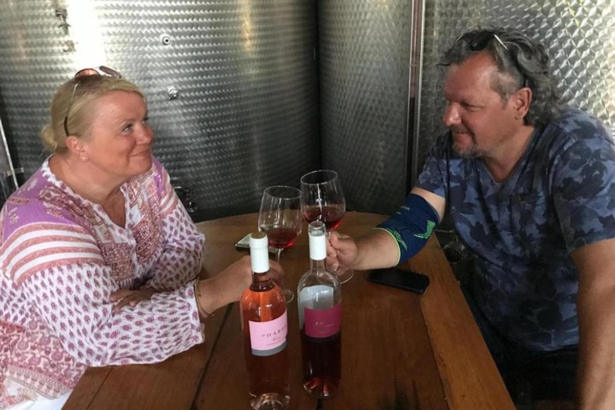 a man and a woman sitting at a table with wine glasses