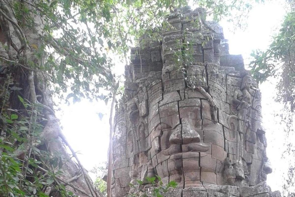 a stone tower with a statue on top of it