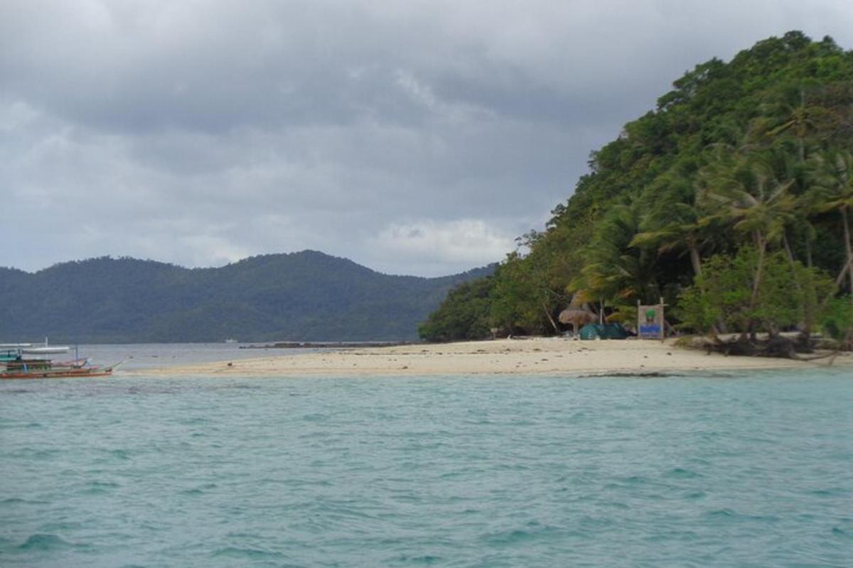 a beach with a boat in the water