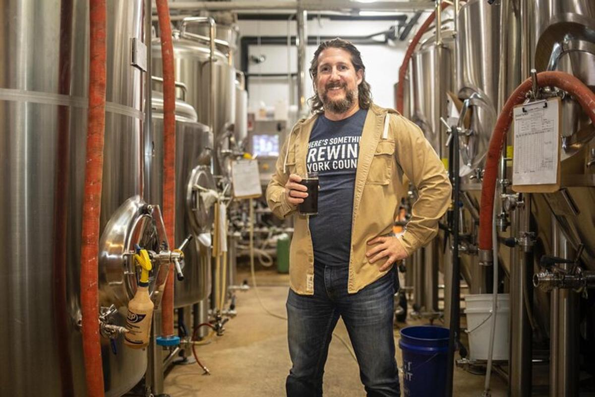 a man is standing in a brewery with