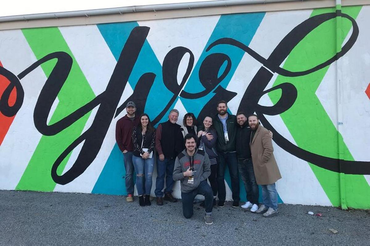 a group of people standing in front of a wall