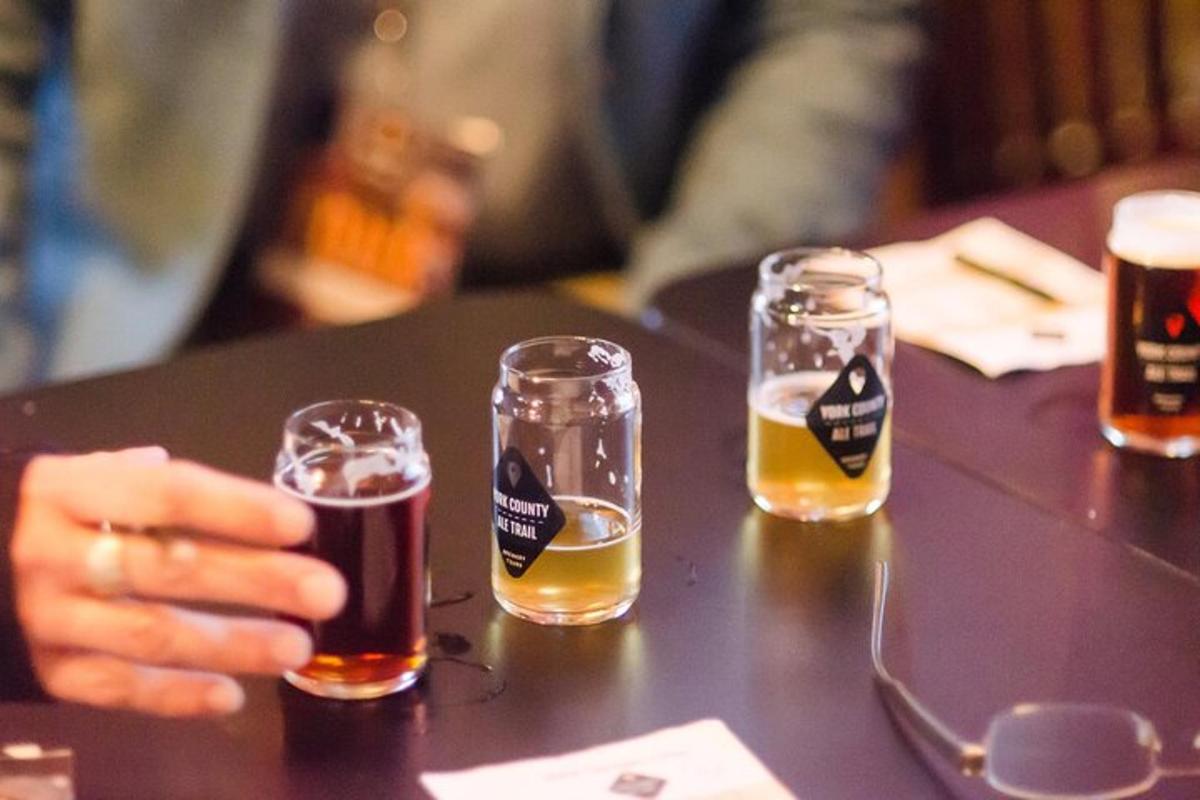 a group of four glasses of beer on a table