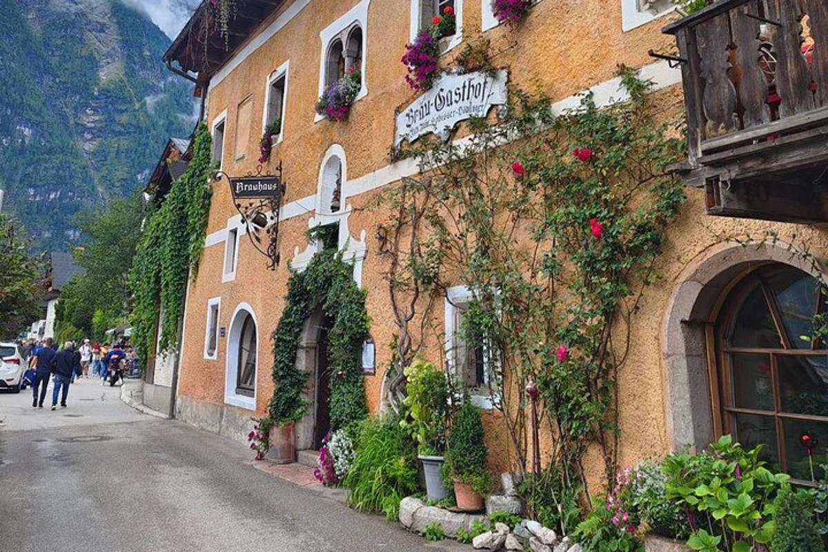 a building with flowers on the side of a street