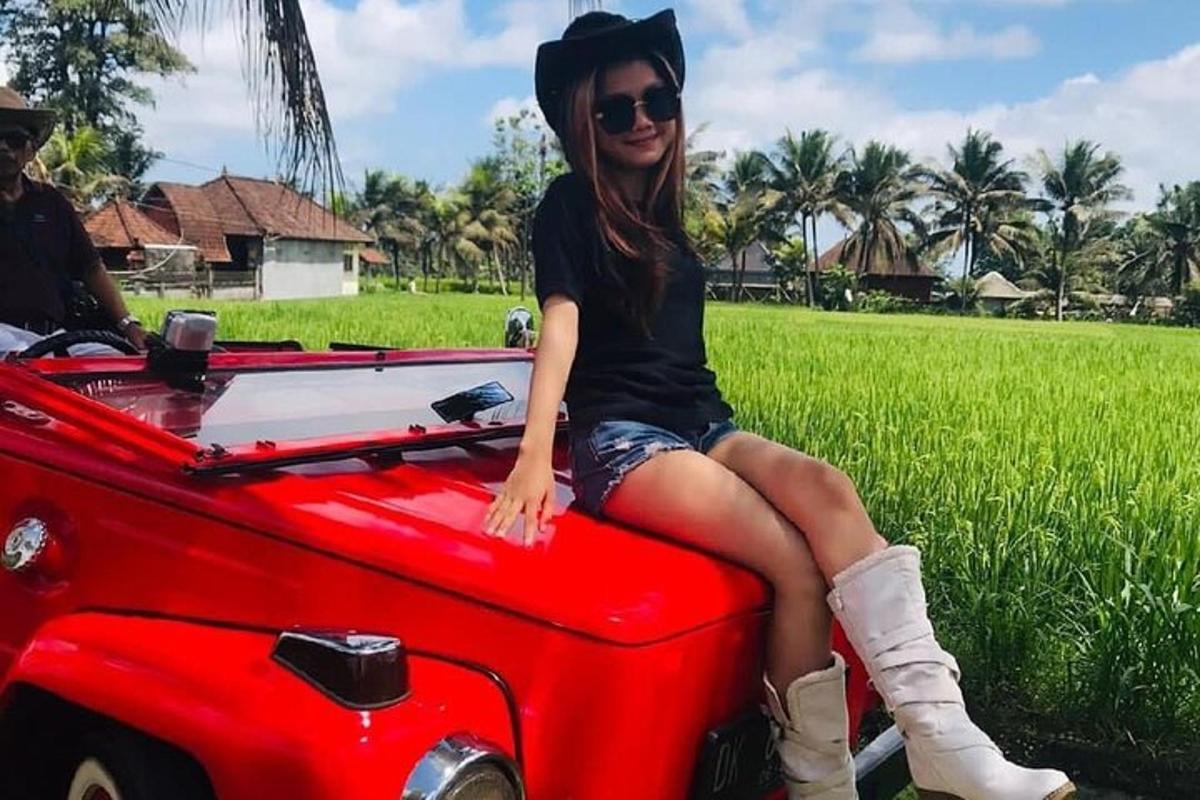 a woman sitting on the back of a red truck
