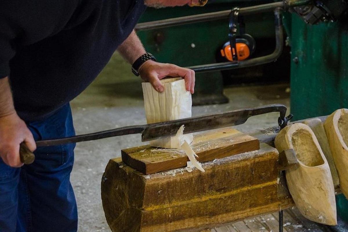 a man cutting a piece of wood with a knife