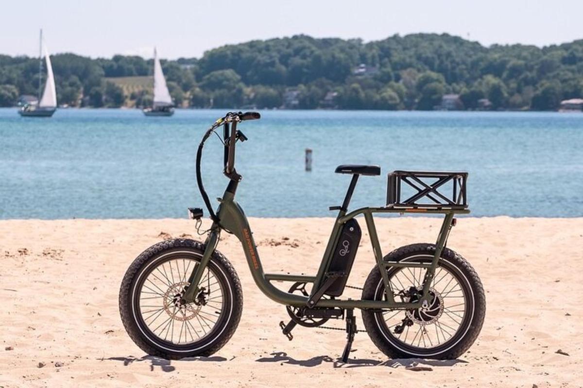 a bike parked on the beach near the water