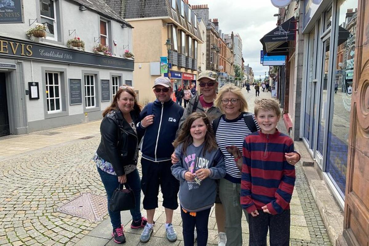 a group of people posing for a picture on a street