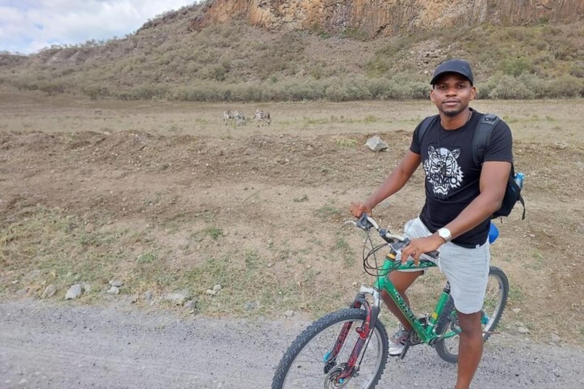 a man riding a bike on a dirt road