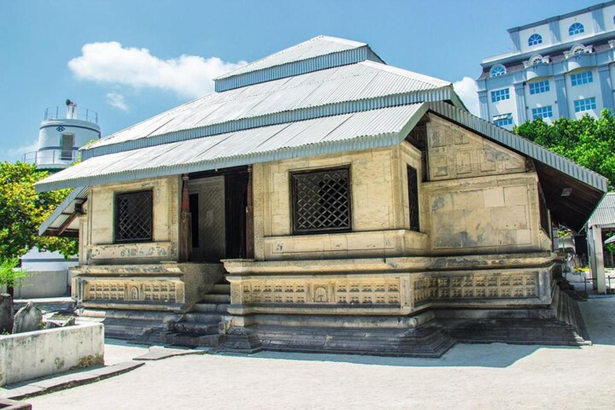 an old building with a tin roof on a street