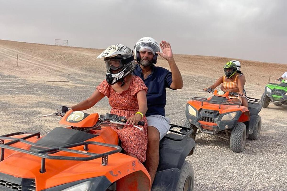 a man and a woman riding on atvs in the desert