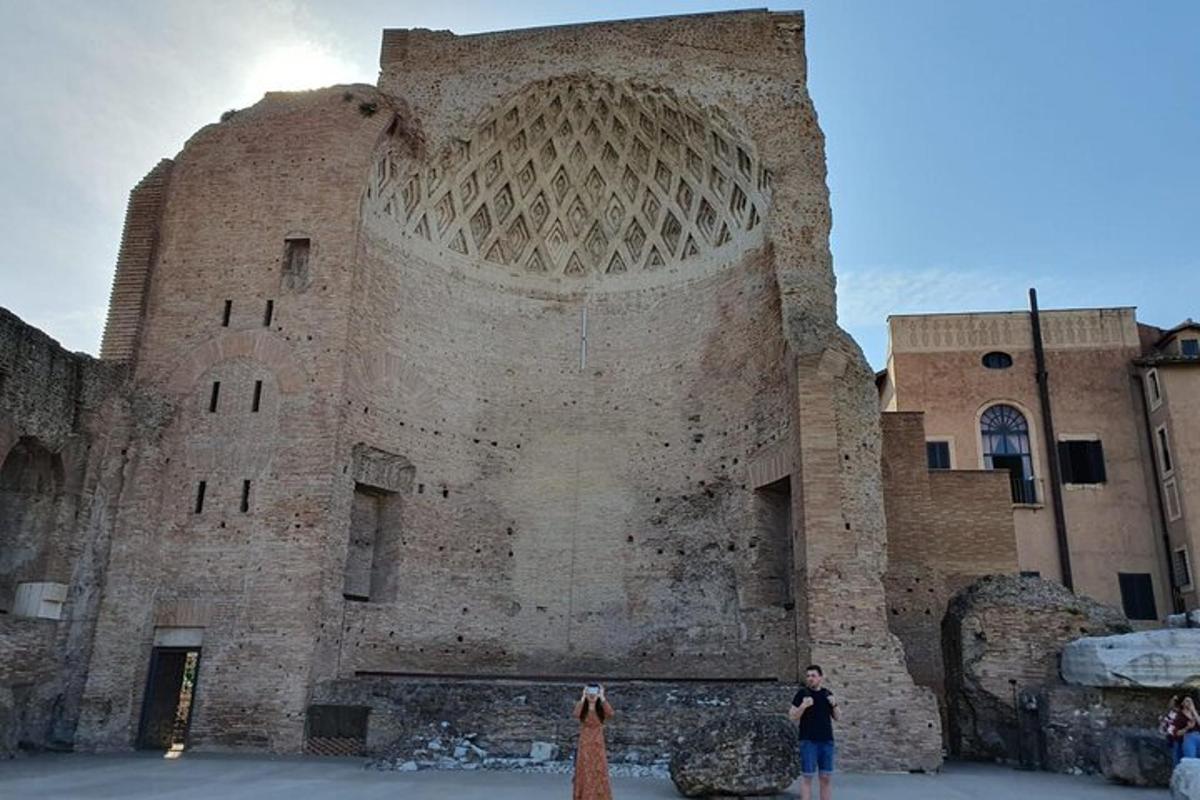 two people standing in front of a large brick building
