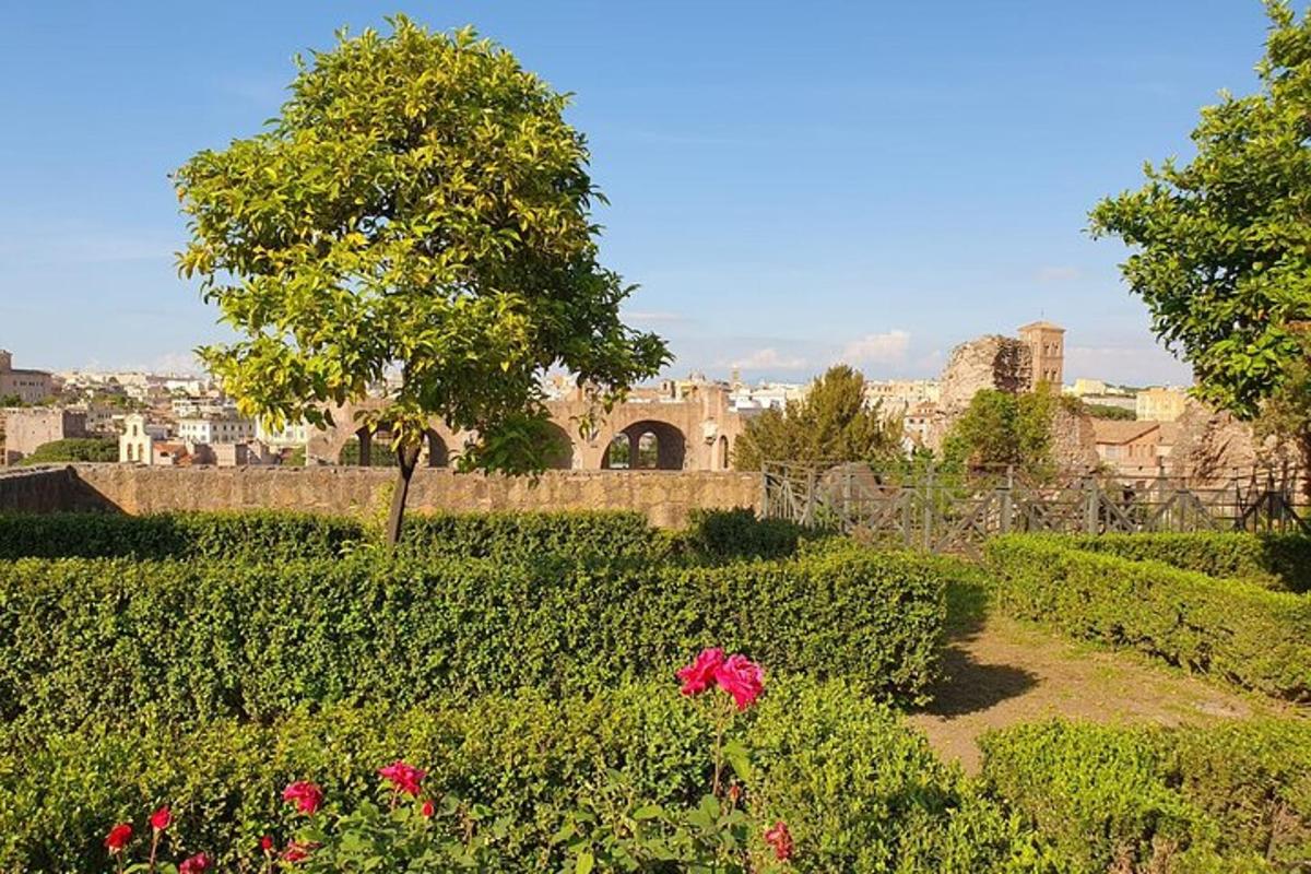 a garden with flowers and a building in the background
