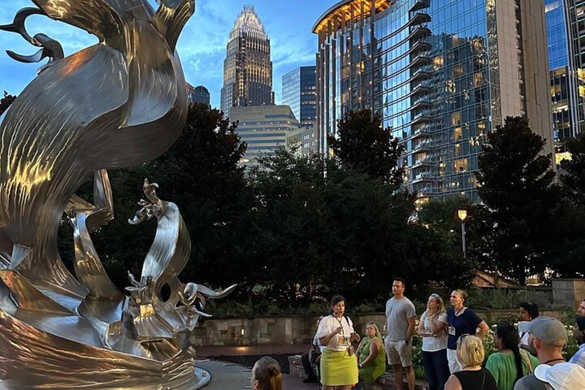 a group of people standing around a statue in a city