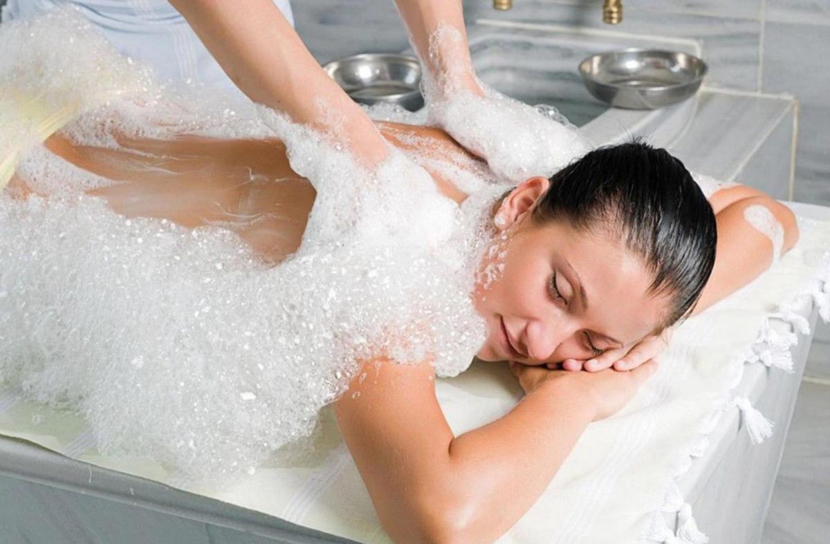 a woman in a bathtub covered in sugar