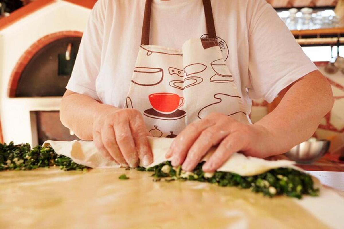a man in apron cutting up vegetables on a counter