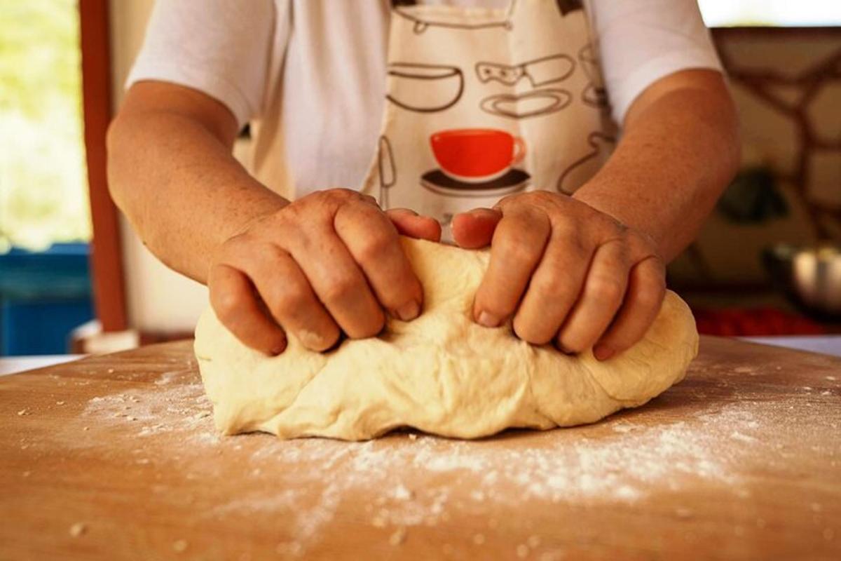a person is kneading the dough on a table