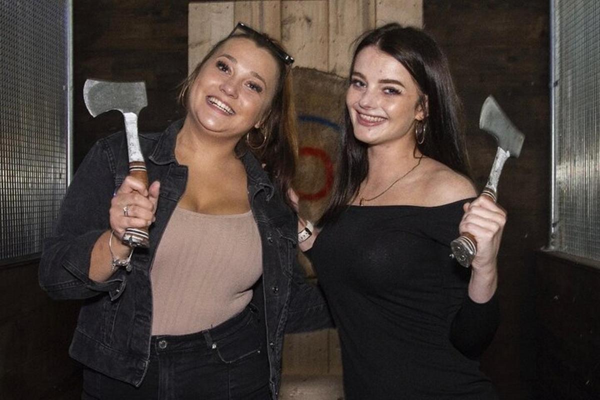 two women are holding shovels in their hands