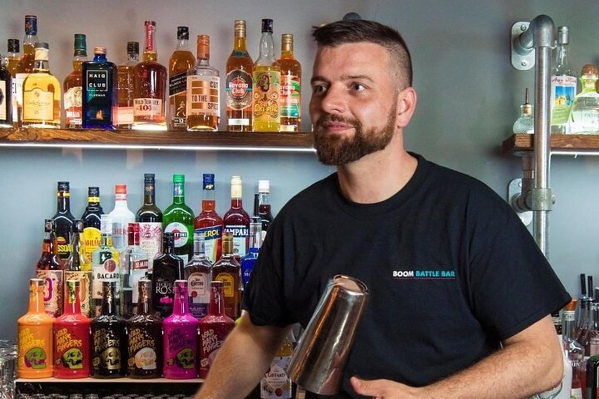 a man standing in front of a bar with bottles of alcohol