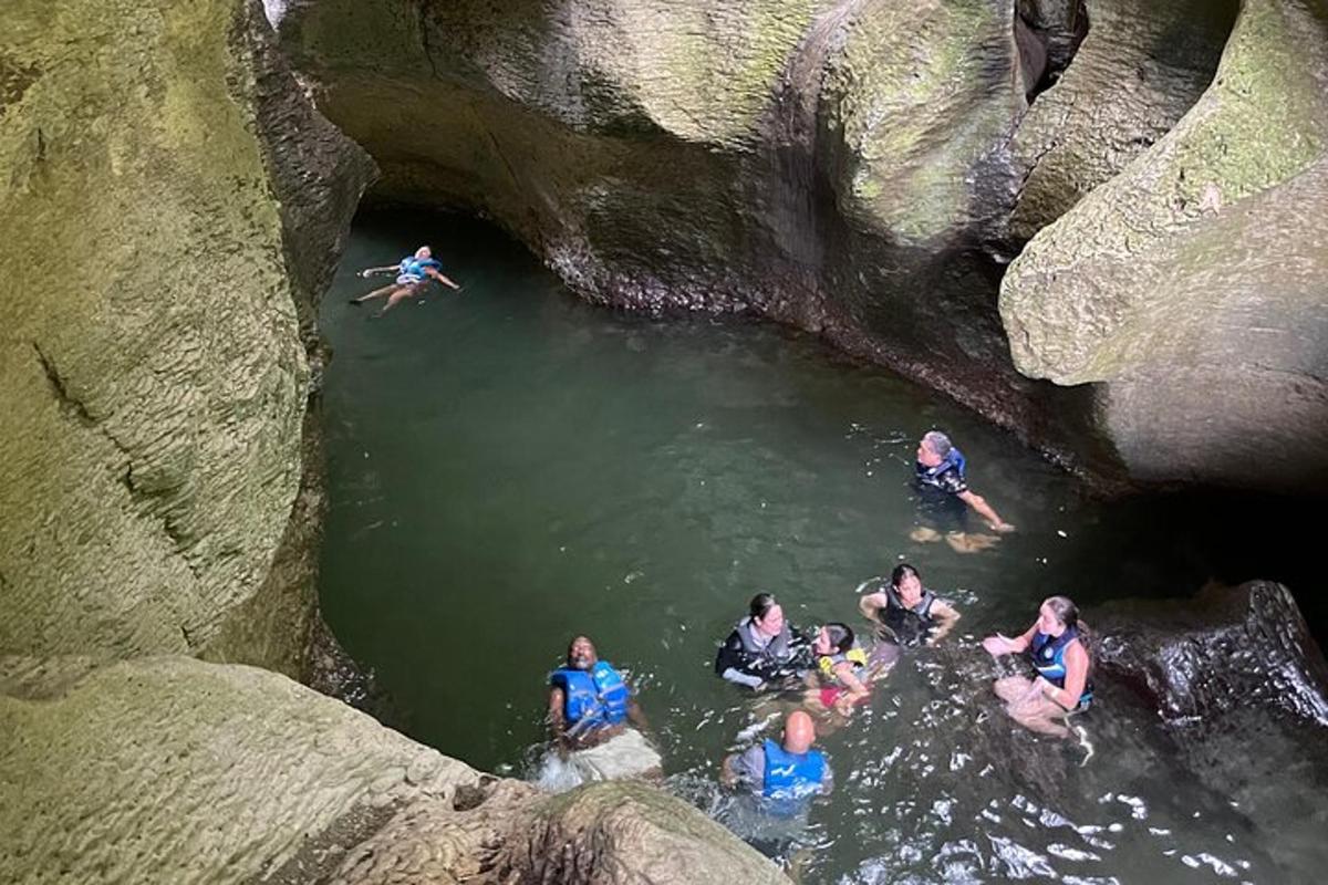 a group of people in the water in a cave