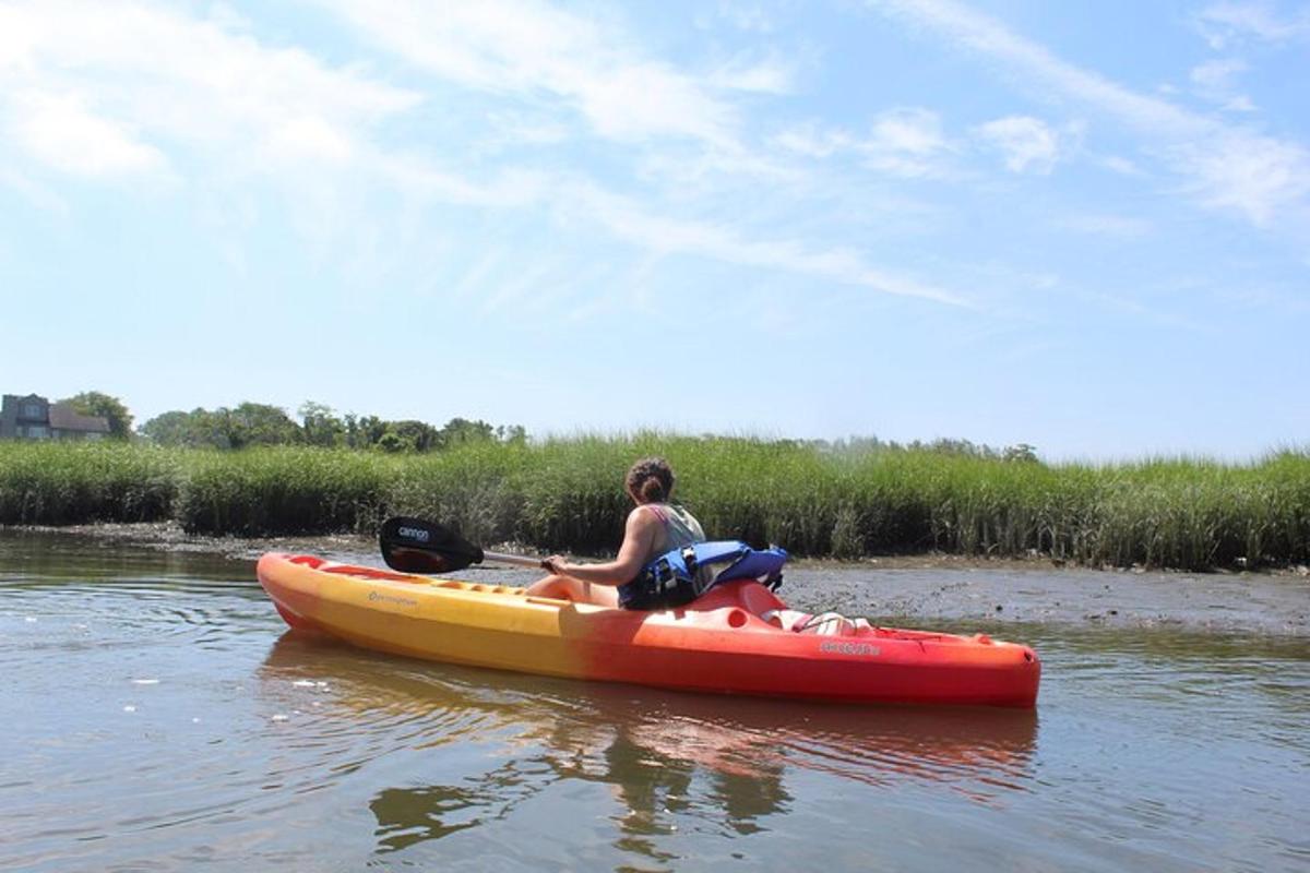 a woman and a man in a red boat on a river