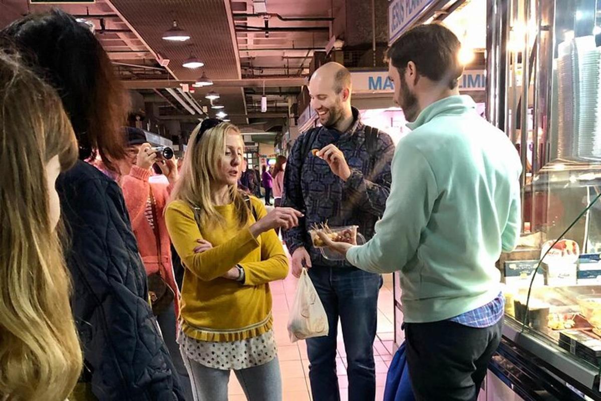 a group of people standing in a store eating food