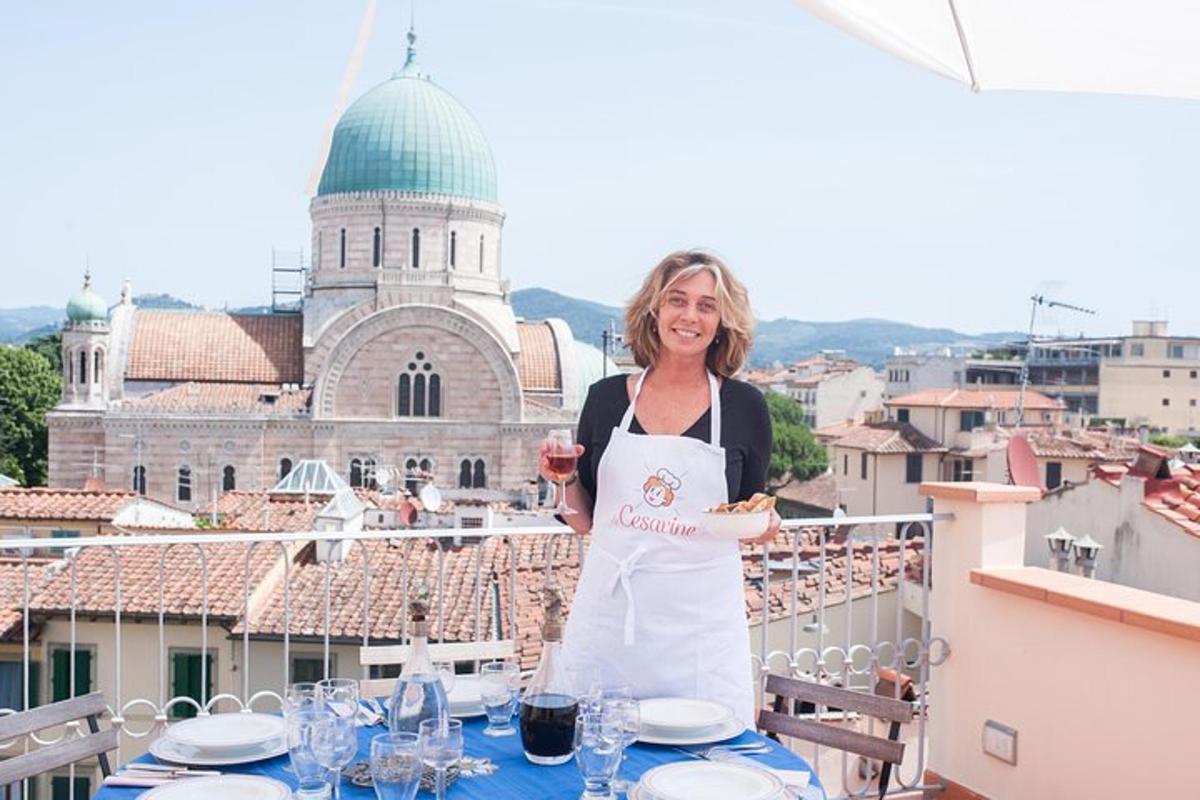 a woman in an apron holding a plate of food on a balcony