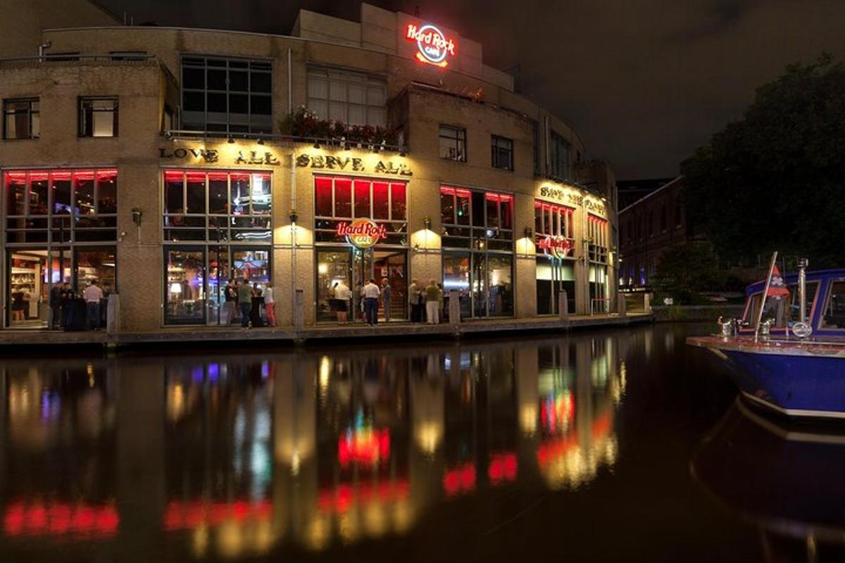 a building with a reflection in the water at night