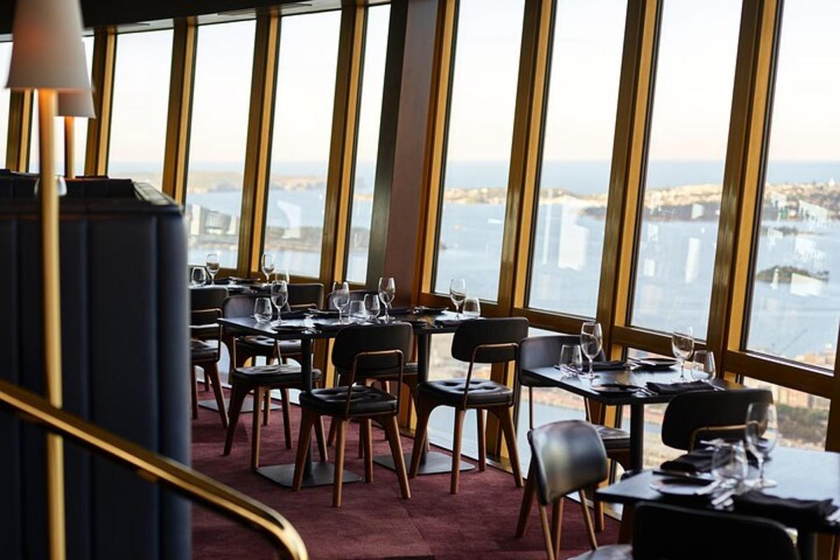 a restaurant with tables and chairs in a room with windows