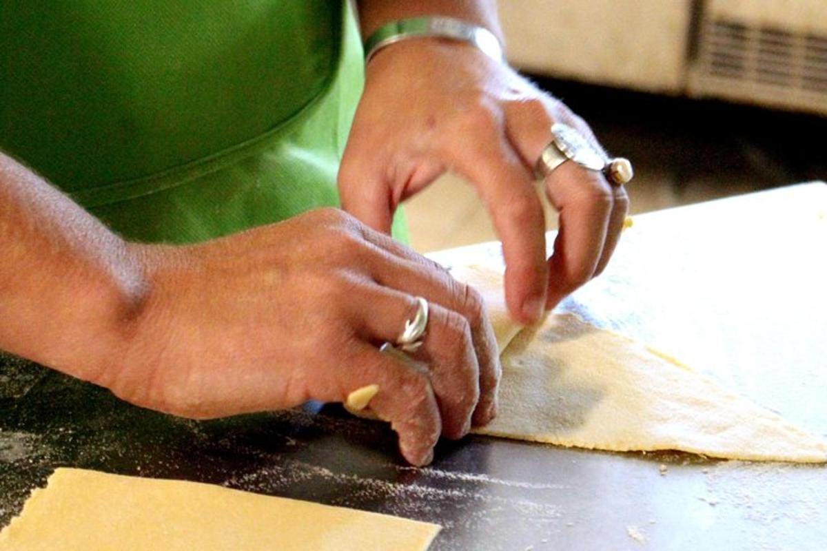 a person kneading a piece of dough on a counter