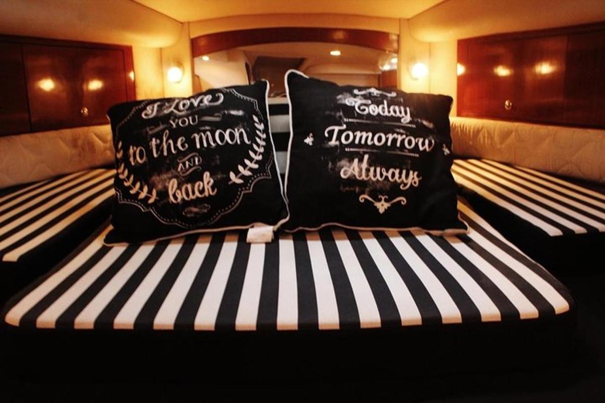 a bed with two pillows on a boat