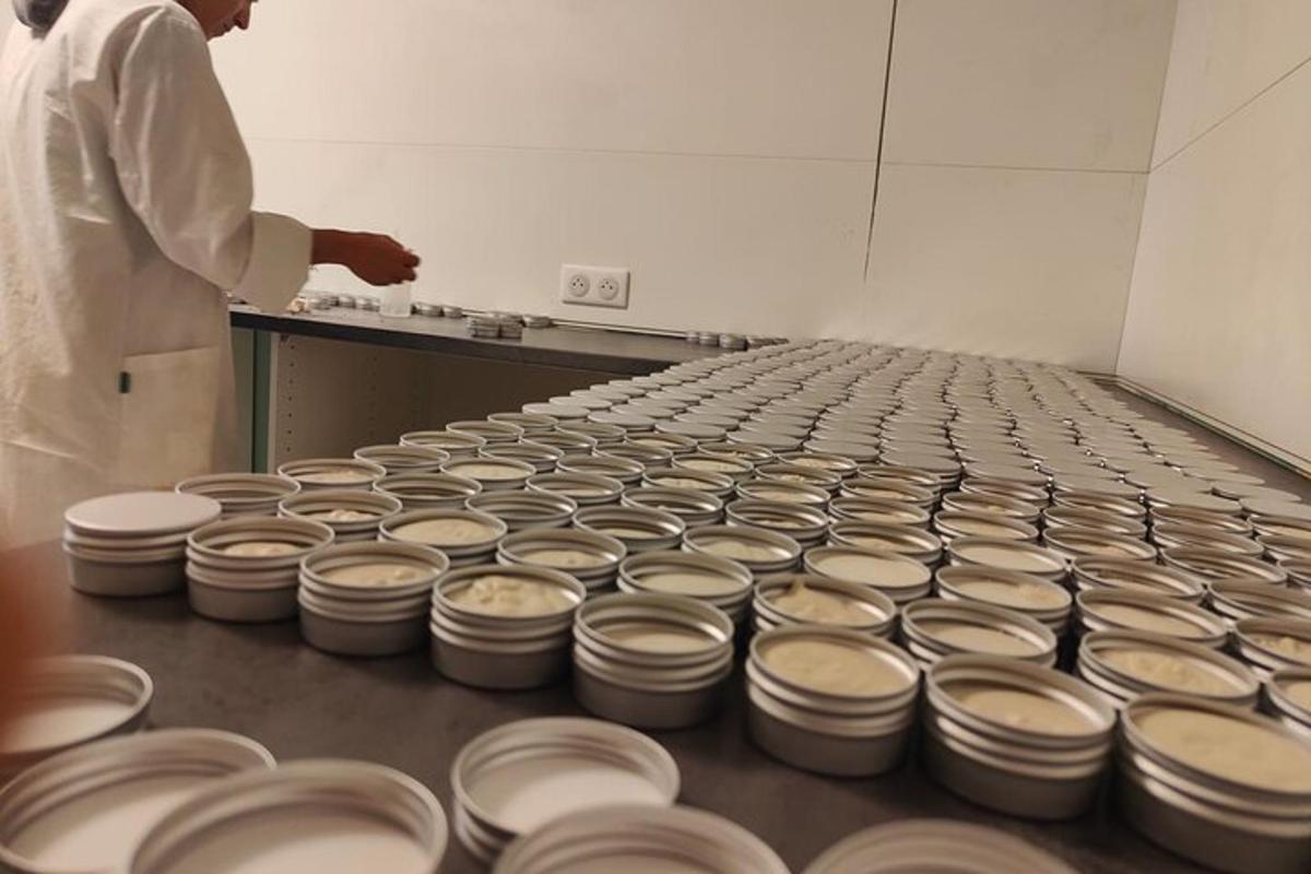 a man standing next to a row of dishes