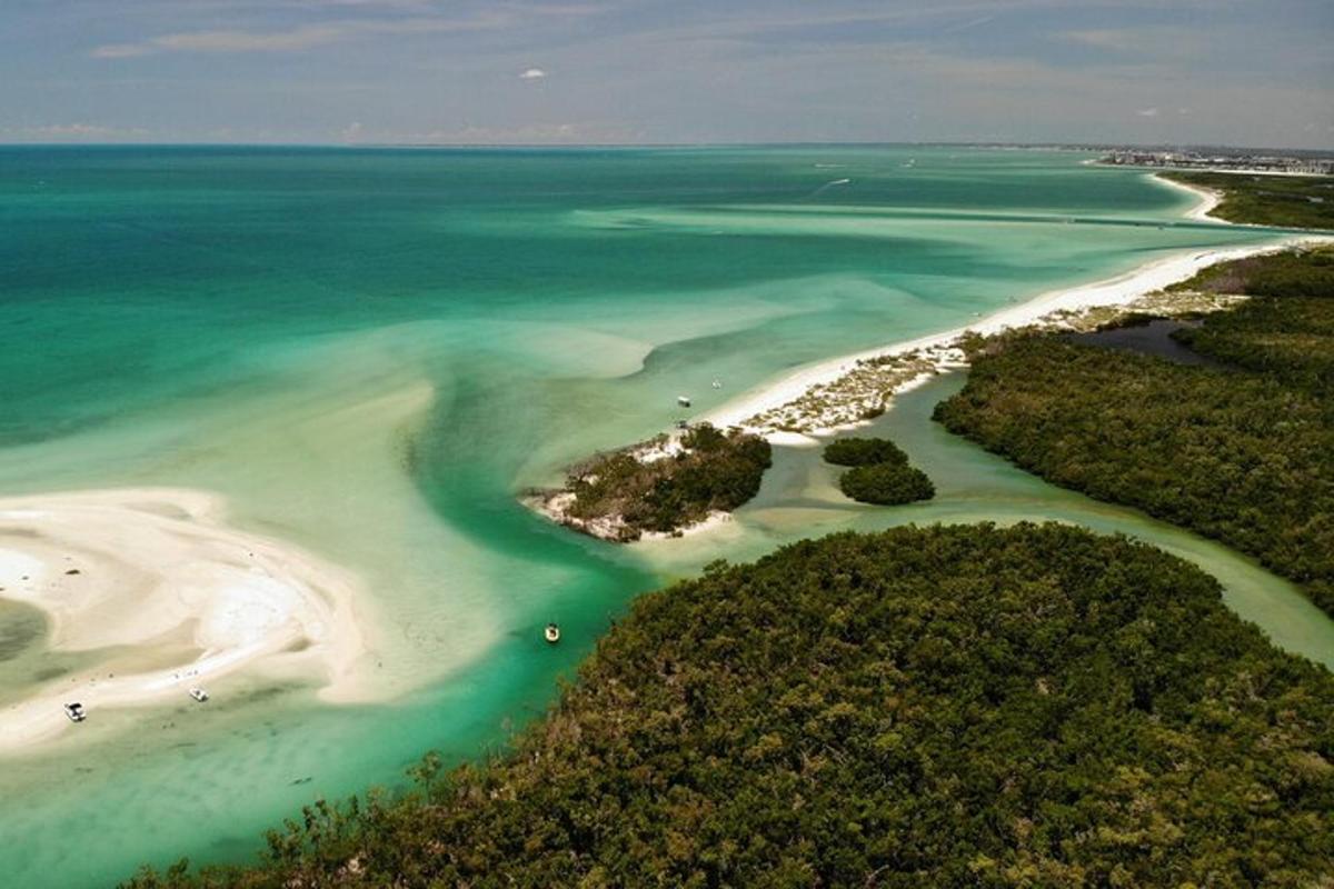 an aerial view of a beach with turquoise water