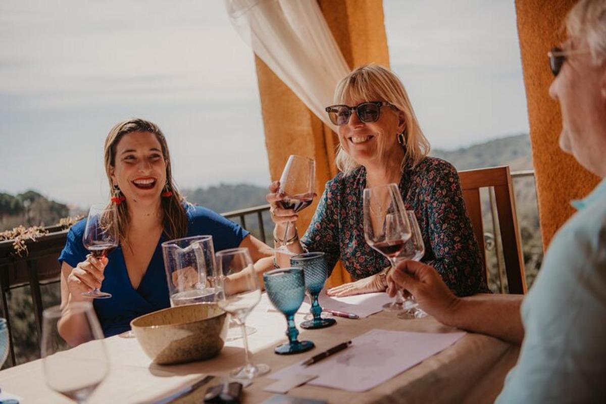 a group of women sitting at a table with wine glasses