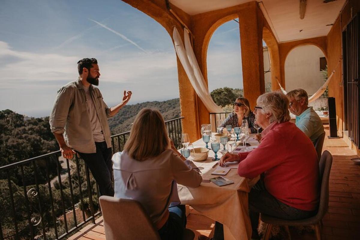 a group of people sitting around a table on a balcony