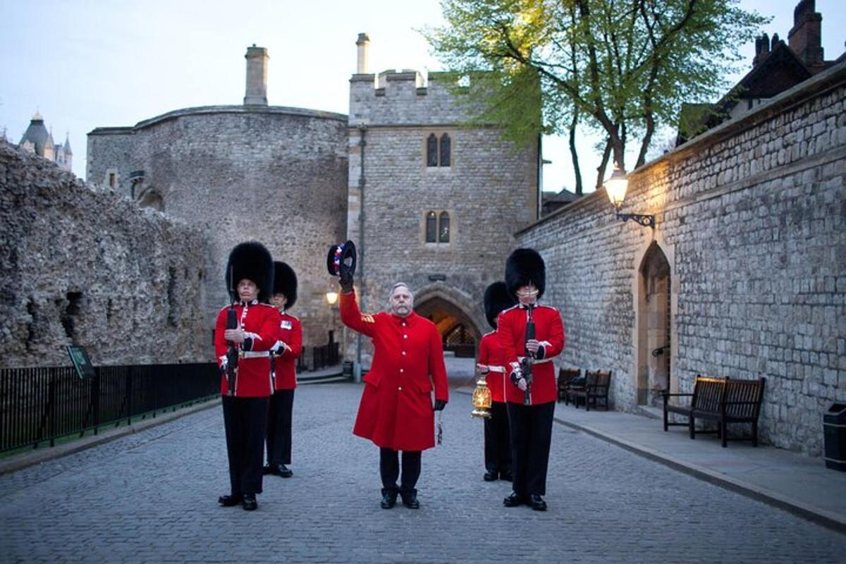 a group of people in red uniforms standing in front of a castle