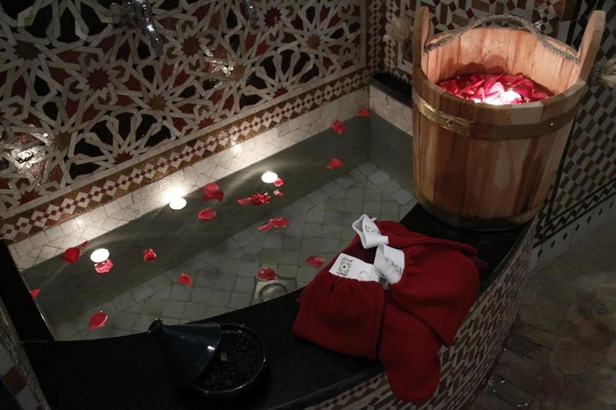an overhead view of a bathroom with red flowers on the floor