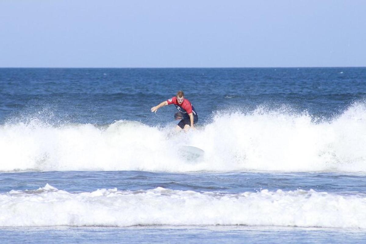 a man riding a wave on a surfboard in the ocean