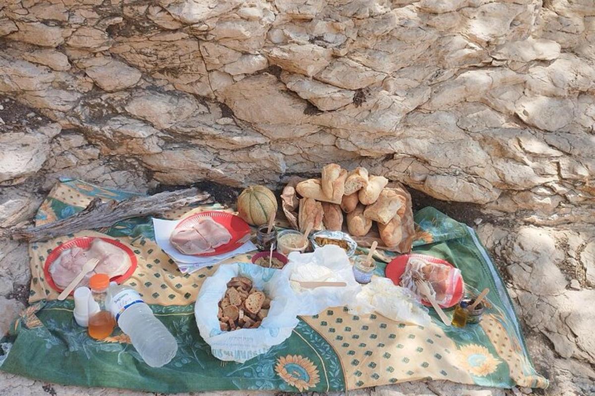 a blanket with food and other items on it