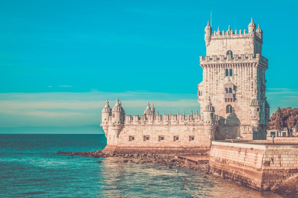 a castle in the water next to the ocean