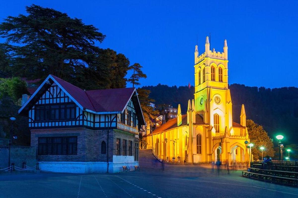 a church with a clock tower at night