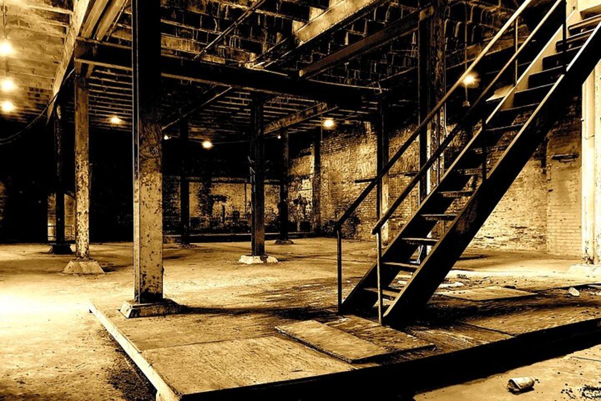 an empty room with a staircase in a building