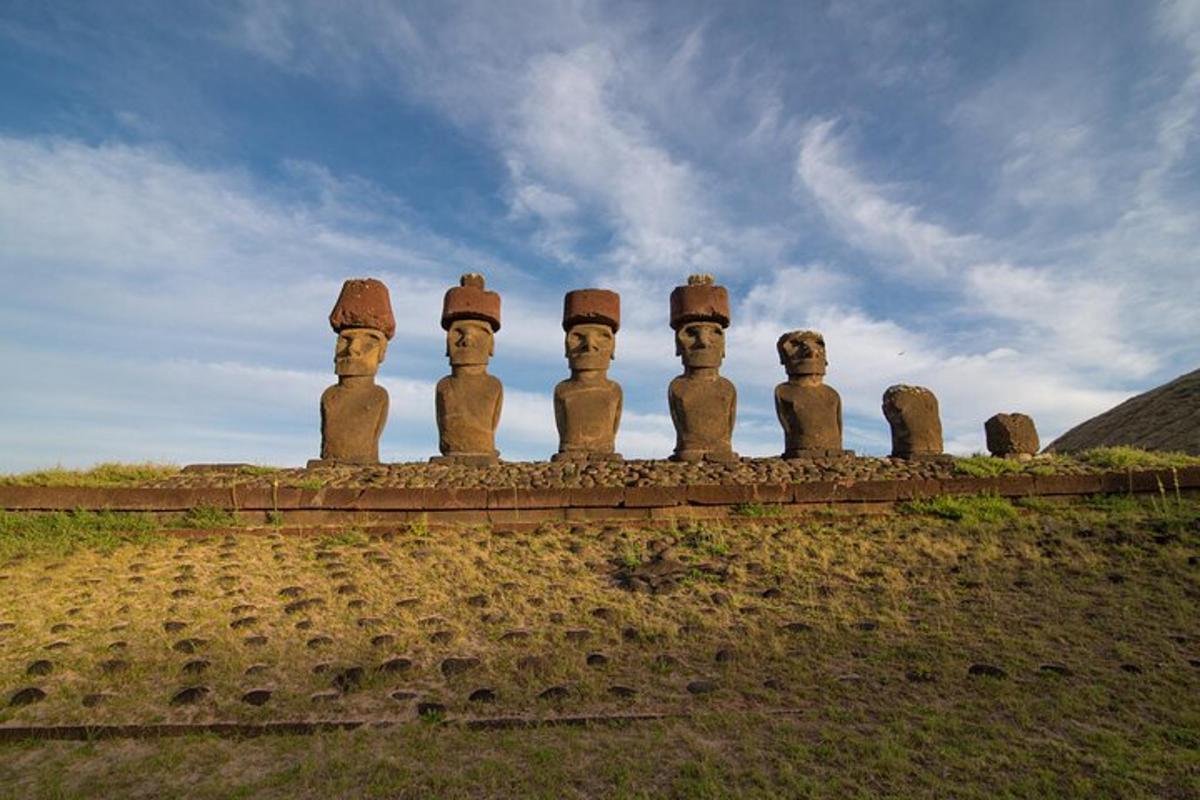 a group of statues sitting on top of a wall