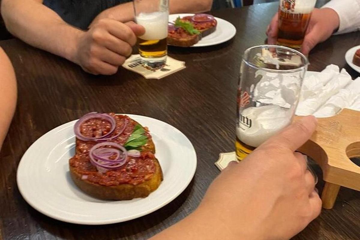 galds ar diviem ēdiena šķīvjiem un glāzi alus