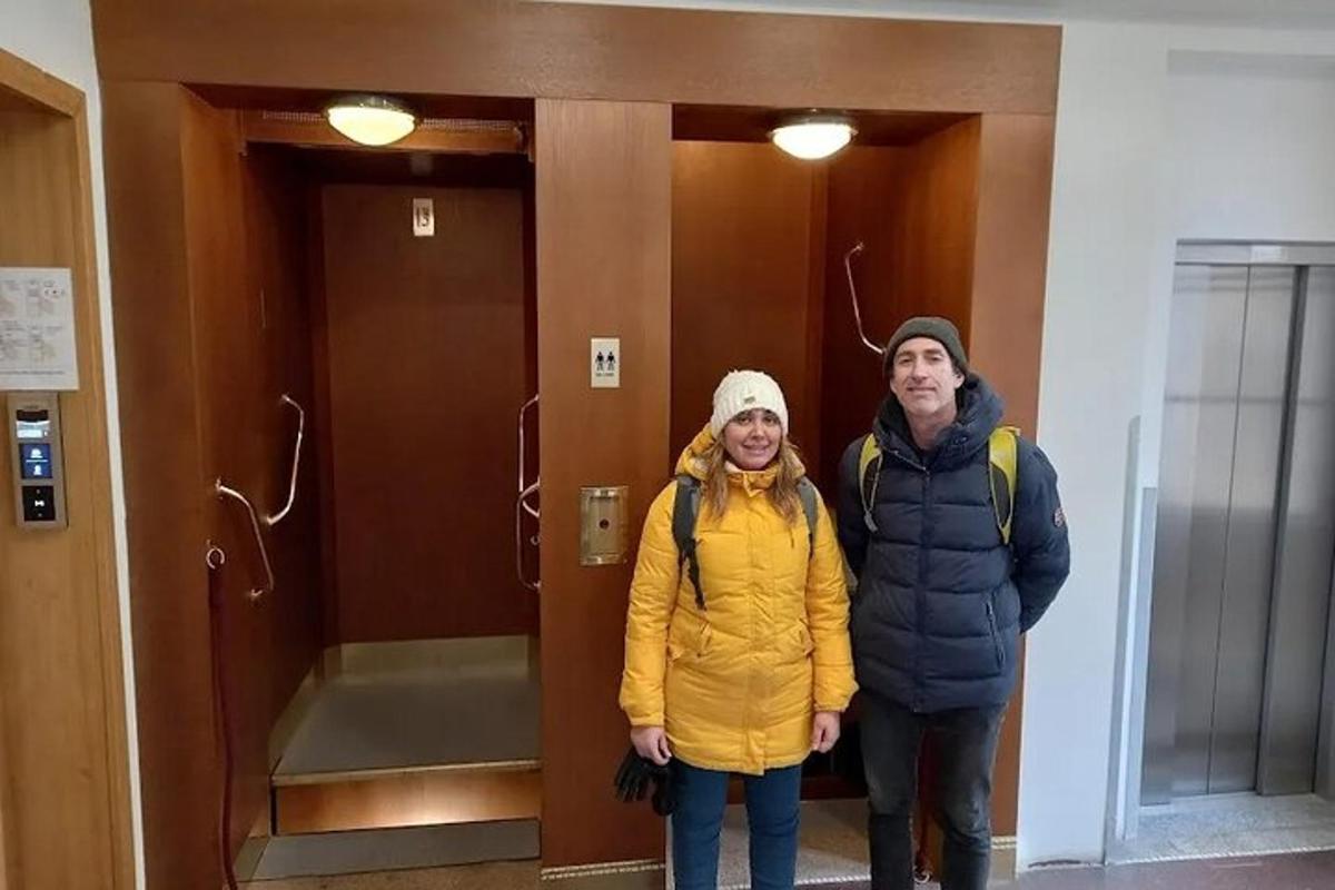 two people standing in front of an elevator