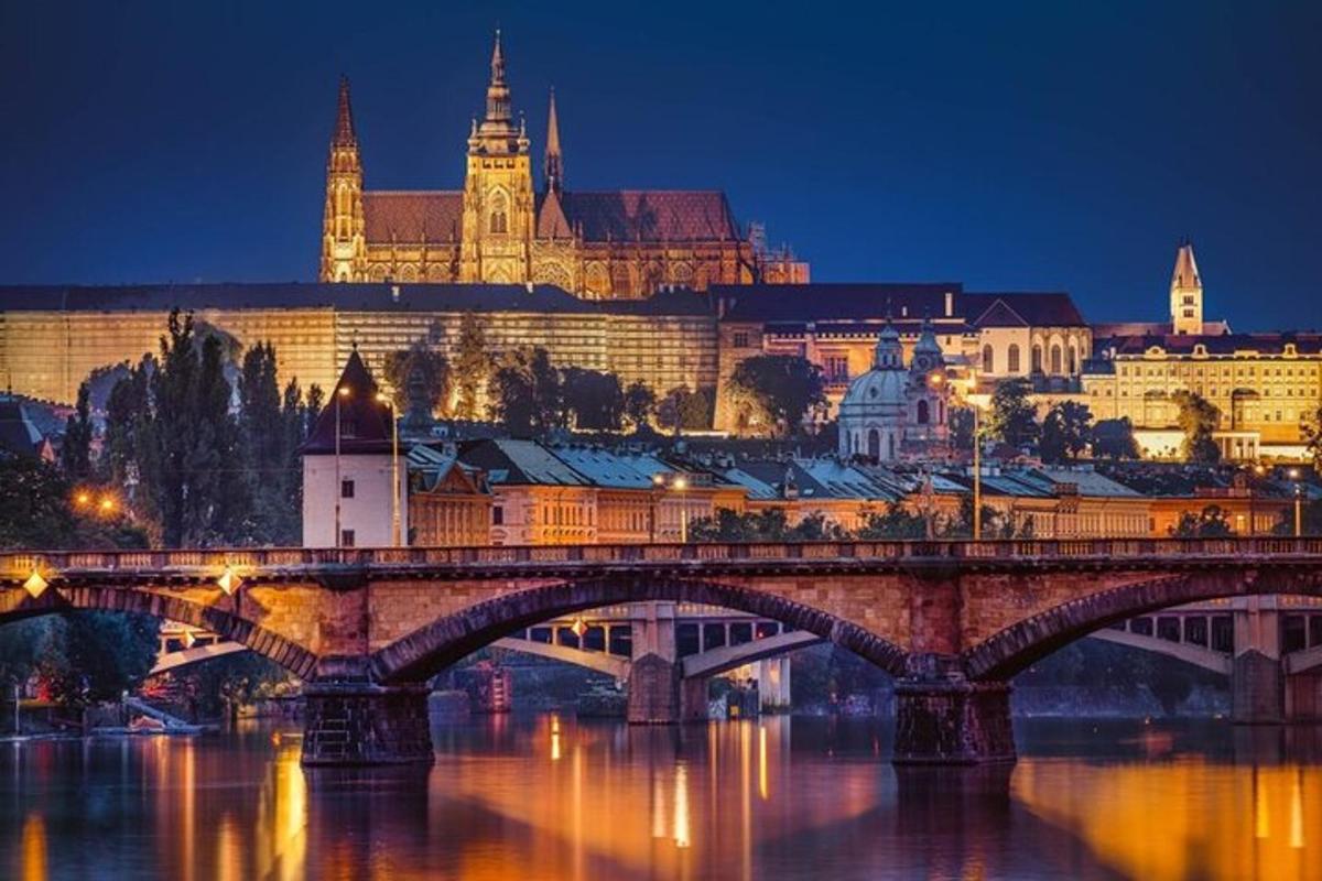 a bridge over a river with a city at night