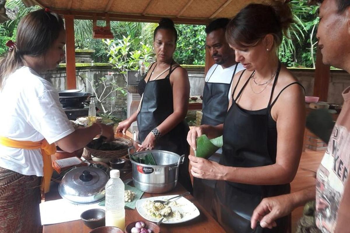 a group of people standing around a table preparing food