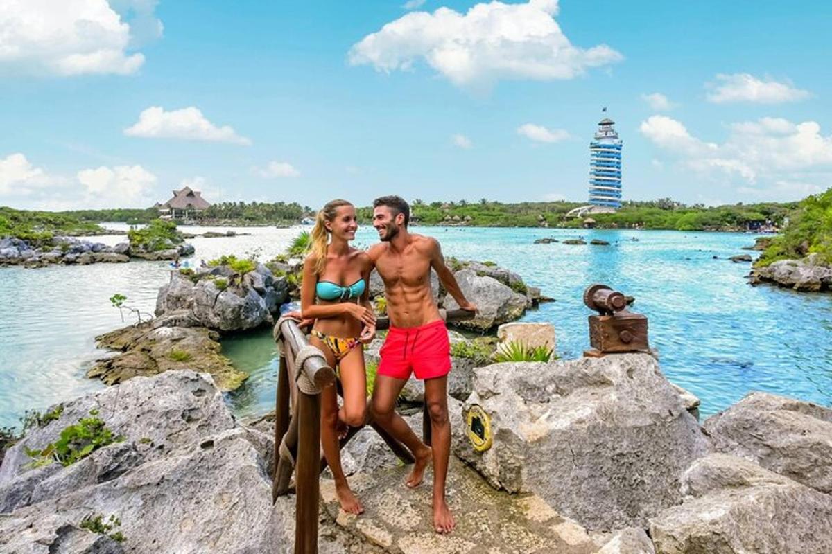 Un hombre y una mujer de pie sobre rocas cerca del agua.